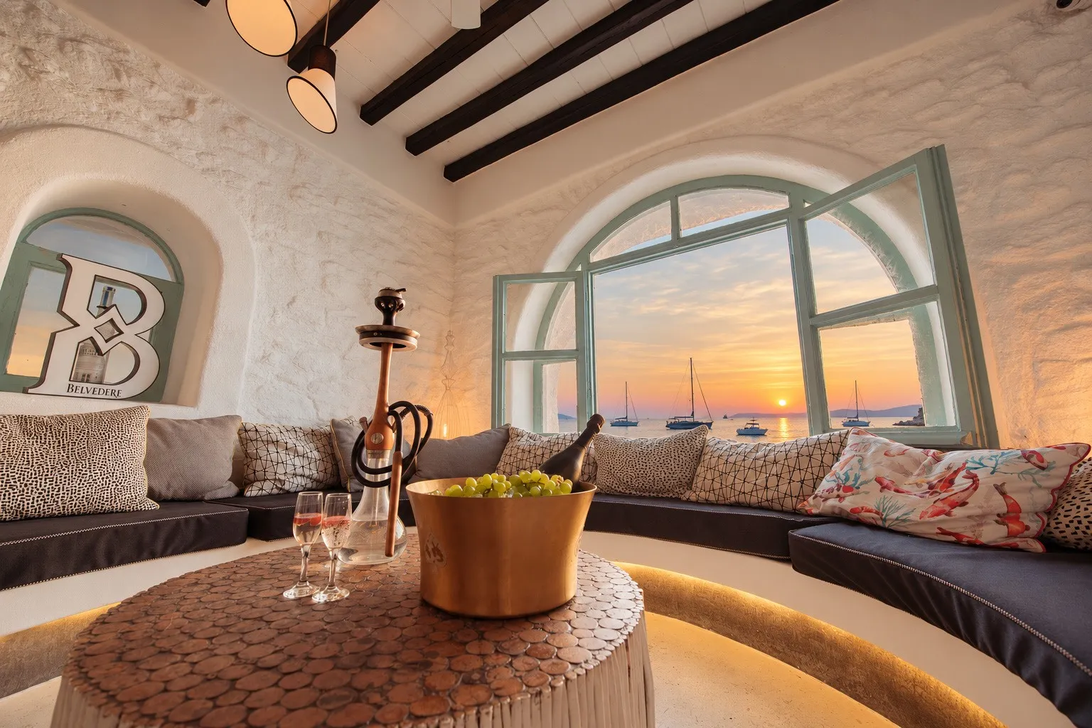 A shisha set up on a low table in the alcove at BAO'S, the arched window open to the sea