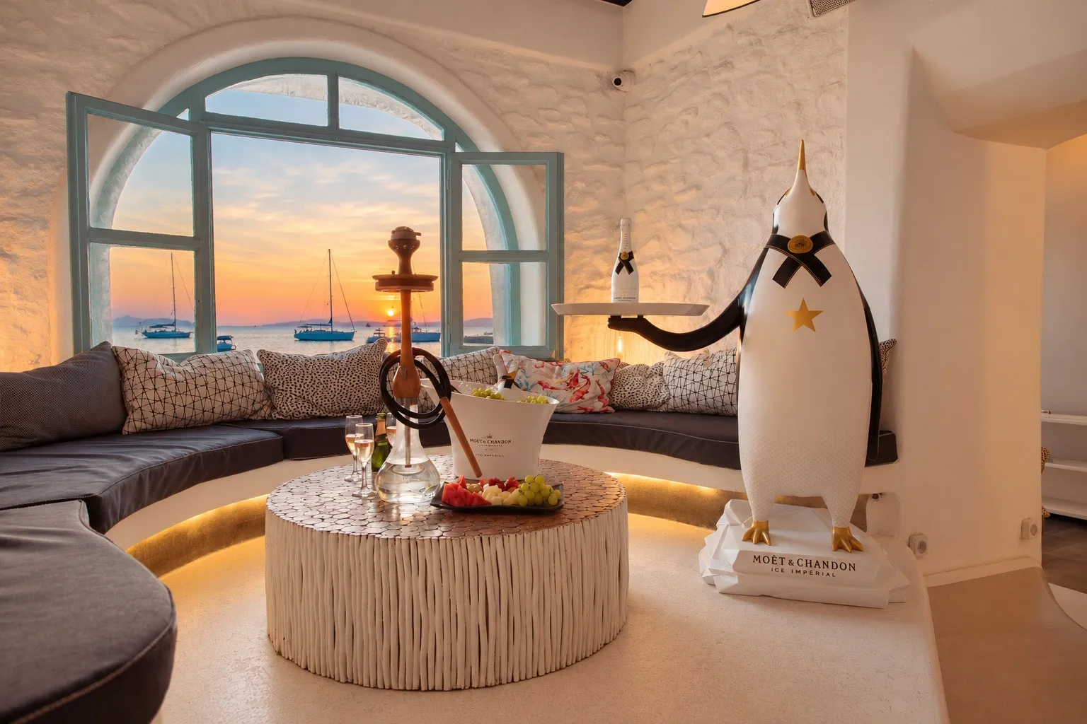 A shisha set on the round table in the curved alcove at BAO'S, the sea through the open window